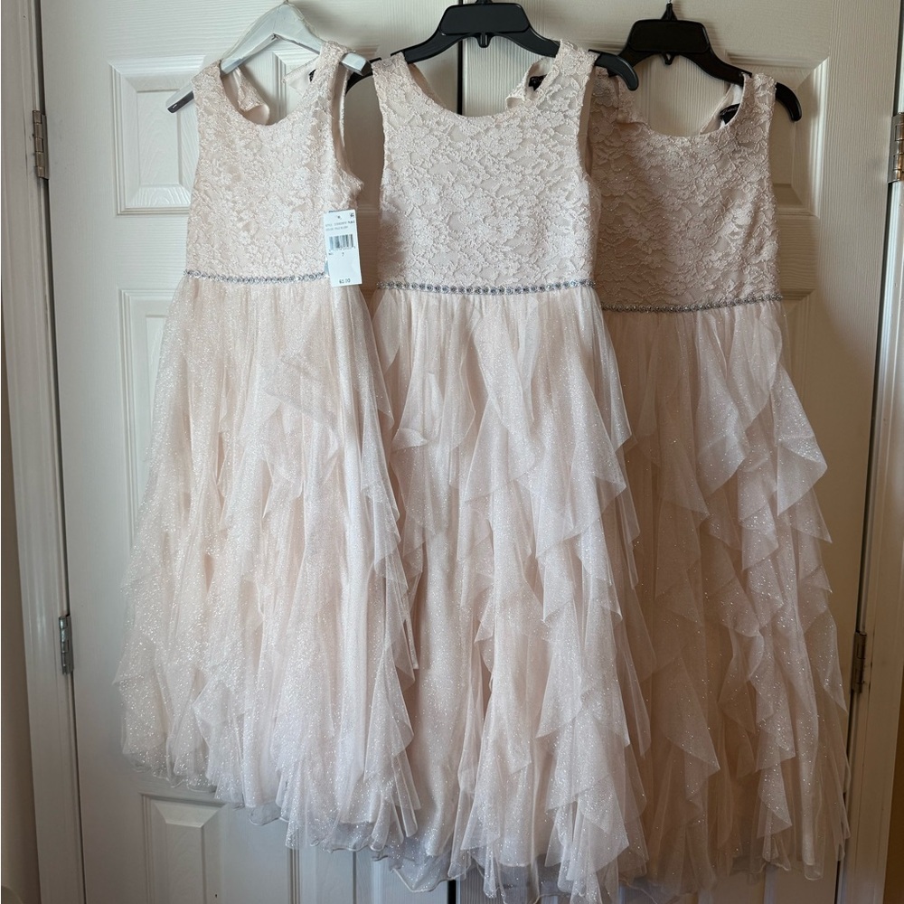 The second dress in the picture is a size 8 light pink girls dress